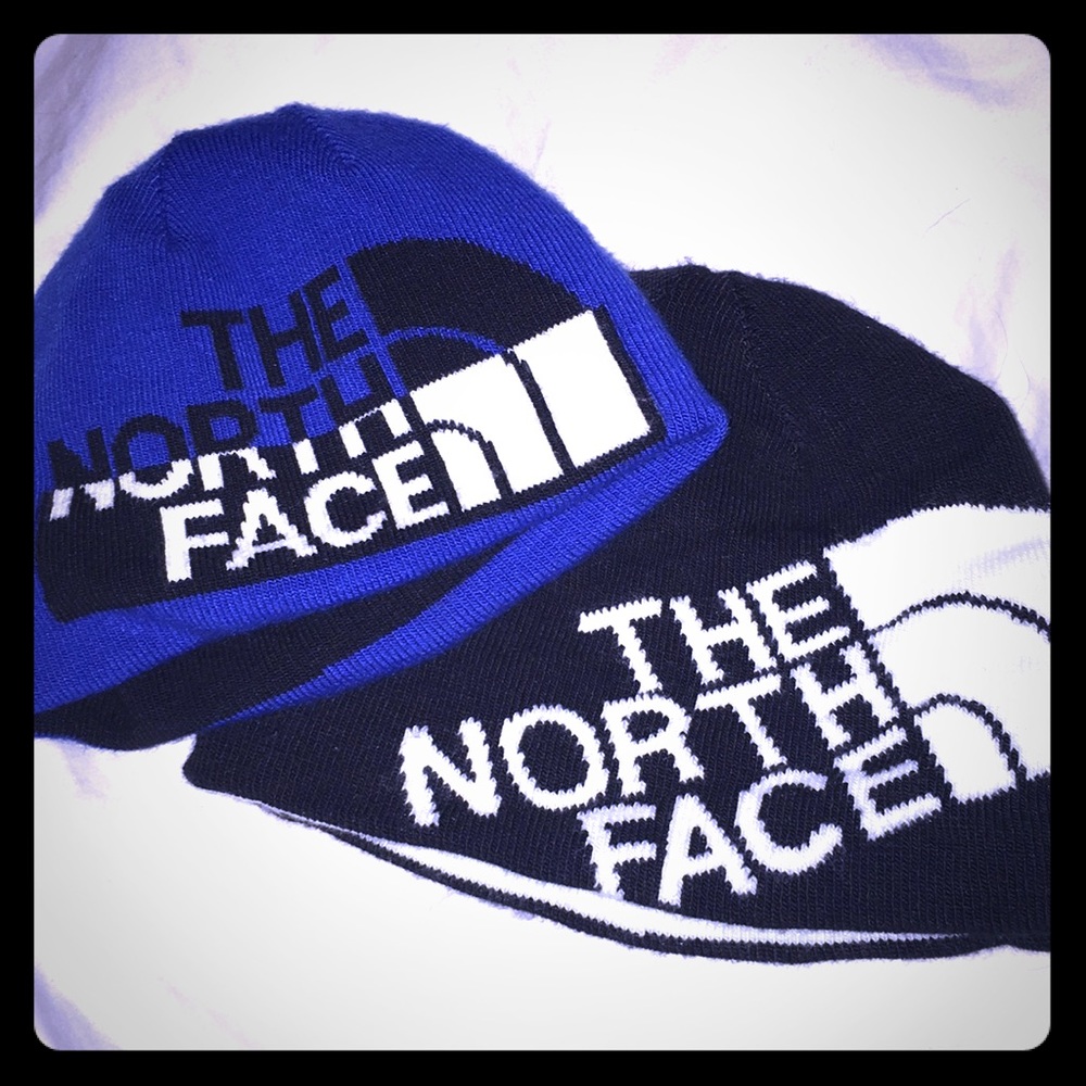A pair of North face toddler winter hats.